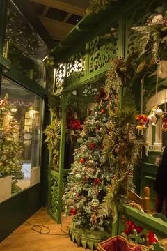 Christmas interior in the store: with a large tree in toys, gingerbread houses. Stock Photos