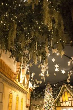 Christmas interior in the store: with a large tree in toys, gingerbread houses. Stock Photos