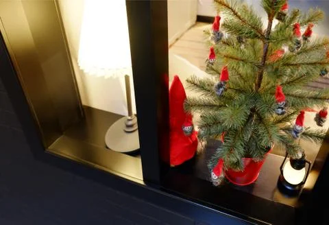 Christmas interior on the window. A small artificial Christmas tree with toys 库存照片