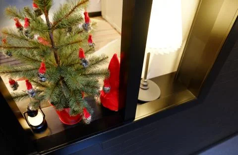 Christmas interior on the window. A small artificial Christmas tree with toys Stock Photos