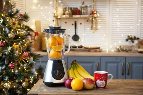 Christmas in the kitchen.Blender with fruit on the table Stock Photos