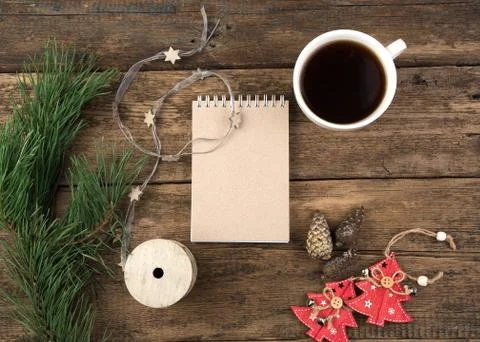 Christmas layout of a coffee Cup, Notepad, spruce branch and Christmas toys. Stock Photos