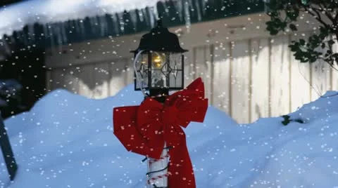 Christmas Light Pole and Red Bow in Snow Stock Footage 8914784