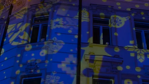 Christmas light show projecting animated holiday symbols onto building Stock Footage 333003150