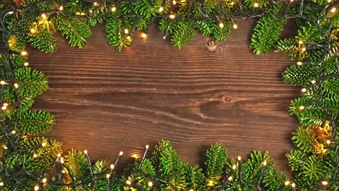 Christmas Lights and Tree Branches Frame on Wooden Background. Seamless Loop. Vídeo Stock 345134592