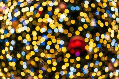 Christmas lights blured background. Light bokeh from Xmas decoration. Stock Photos