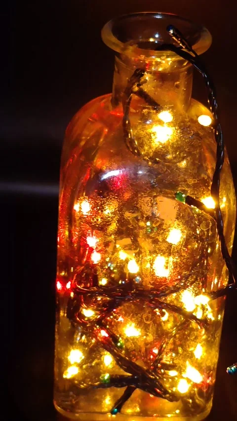 Christmas lights in a bottle, beautiful decor, macro photography in the dark Stock Footage 323761325