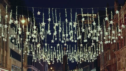 Christmas Lights Decorations Featuring Hanging Stars on a City Street at Night Stockbeeldmateriaal 331105573