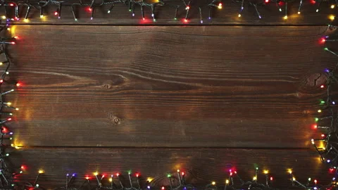 Christmas lights frame loop on rustic wooden background. Stock Footage 284517737