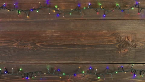 Christmas lights frame loop on rustic wooden background. Stock Footage 285891247