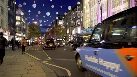 Christmas lights, red buses and black cabs on busy Oxford Street. London, UK Stock Footage 100623355