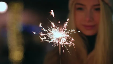Christmas lights splashes burn in hands blonde woman smiling Stock Footage 137172310