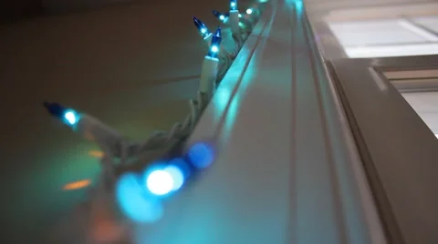 Christmas lights strung up on a window frame Stock Footage 44447903