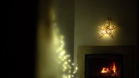 Christmas lights on the tree. A live fire burns in the fireplace. A Christmas Stock Footage 144382677