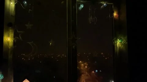 Christmas lights on the window with night view and snowing Stock Footage 166170444