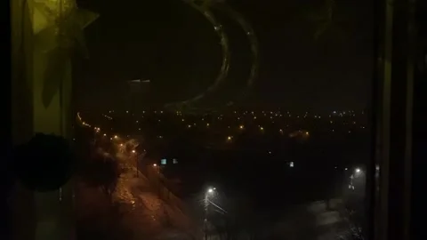 Christmas lights on the window with night view and snowing Stock Footage 166170446