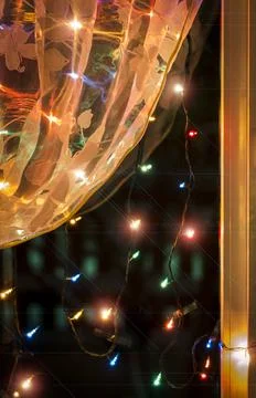 Christmas lights in the window. Stock Photos