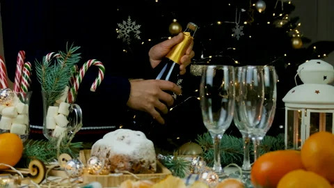 Christmas man opens champagne. Selective focus. Stock Footage 224352934