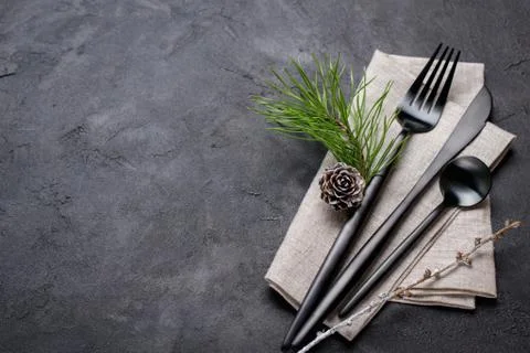 Christmas menu concept . Flat lay with Xmas decorations and pine cones, dark Stock Photos