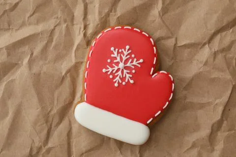 Christmas mitten shaped gingerbread cookie on crumpled parchment, top view Stock Photos