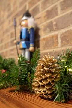 Christmas nutcracker with brick background and decorations with brick firepla Stock Photos