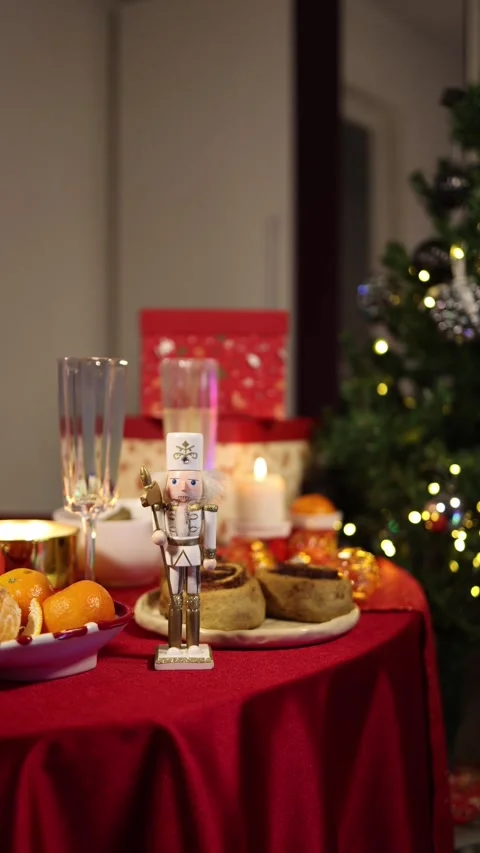 Christmas nutcracker on festive table with tangerines candles and pastries 库存影片 347141281