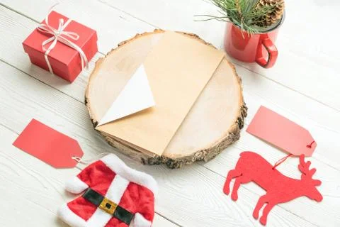 Christmas objects including paper card, Santa toy costume, deer toy, mug with Stock Photos