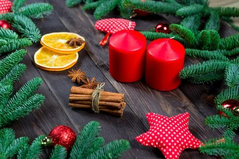 Christmas objects on a wooden table, close-up of candles, spices and spruce b Stock Photos