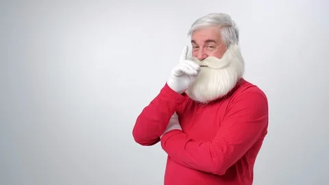 Christmas old man with beard in red hat, winking and point finger on camera Stock Footage 123421052