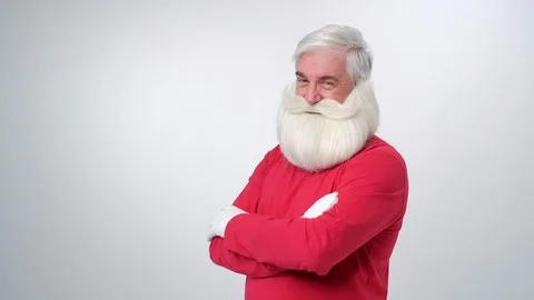 Christmas old man with beard in red hat, winking and point finger on camera Stock Footage 123421832