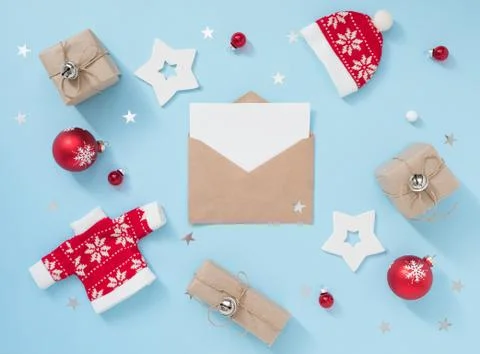Christmas or winter composition with envelope and red decorations on pastel blue Stock Photos