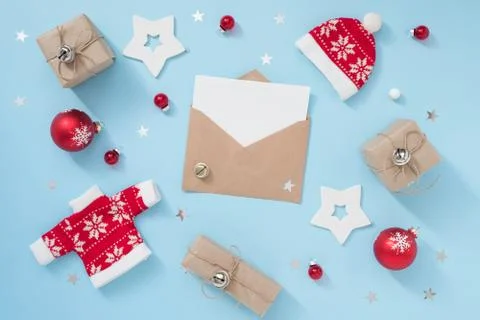 Christmas or winter composition with envelope and red decorations on pastel blue Stock Photos