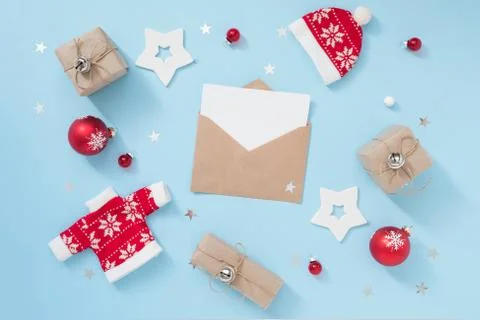 Christmas or winter composition with envelope and red decorations on pastel blue Stock Photos