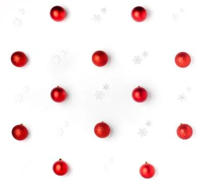 Christmas or winter composition. Pattern made of red balls and white snowflak Stock Photos
