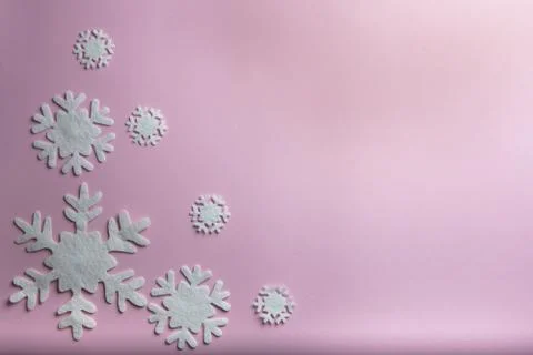 Christmas or winter composition. Pattern made of snowflakes on pastel pink ba Stock Photos