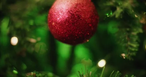 Christmas Ornament Hanging on a Pine Tree with Sparkling Festive Fairy Lights 库存影片 331105372