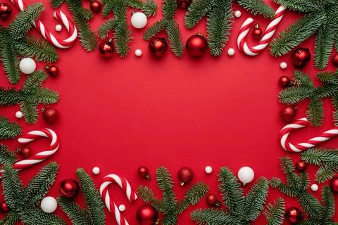 Christmas ornaments Frame with fir branches on a red background Stock Photos