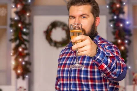 Christmas party toast with wine glass by man, only one person in frame, festi Stock Photos