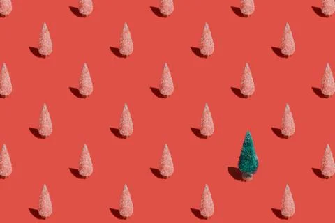 Christmas pattern background of Christmas trees on red texture. Minimal New Year Stock Photos