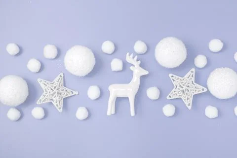 Christmas pattern border. Deer, balls, white stars on a purple pastel backg.. Stock Photos