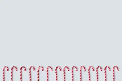 Christmas pattern of candy canes on a white background Stock Photos