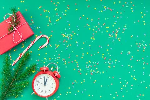 Christmas pattern flat lay with red alarm clock Stock Photos