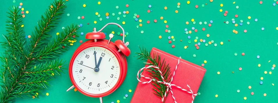 Christmas pattern flat lay with red alarm clock Stock Photos