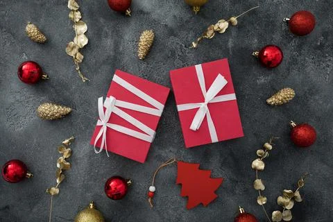 Christmas pattern with gift box and golden decoration on dark background. New Stock Photos