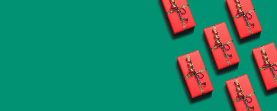 Christmas pattern with red present box, ribbons on red background. Creative f Stock Photos