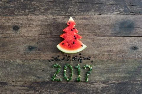 Christmas pattern. Slices of watermelon in the shape of christmas trees. Stock Photos