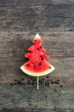 Christmas pattern. Slices of watermelon in the shape of christmas trees. Stock Photos