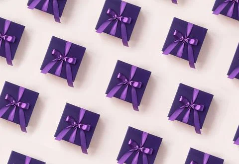 Christmas pattern. Violet gift box with a purple bow made of satin pattern on Stock Photos