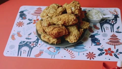 Christmas-patterned table presenting a finished chicken meal Stock Footage 342129513