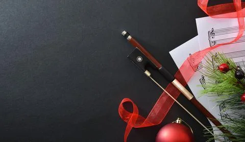 Christmas performance concept of stringed instruments with bow on black Stock Photos